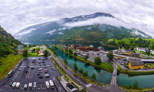 Aerial view of the village of Flam situated along the Aurlandsfjord featuring a parking lot harbor area and surrounding mountains in Flam Vestland Norway. Aerial view of the village of Flam situated along the Aurlandsfjord featuring a parking lot harbor area and surrounding mountains in Flam Vestland Norway.