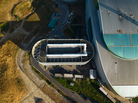 Aerial view of the Energy Recovery Facility featuring its distinctive oval shaped structure industrial roof and surrounding infrastructure in Bicester England United Kingdom.