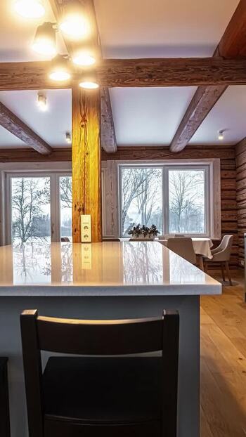View of modern rustic interior with wooden beams in Latvia. View of modern rustic interior with wooden beams in Latvia.