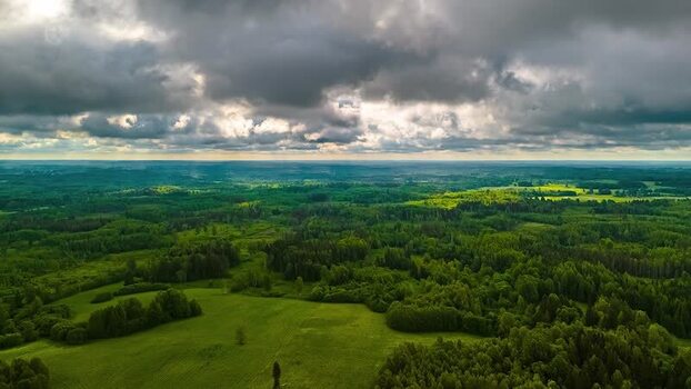 Aerial view of lush green forests and meadows in Latvia. Aerial view of lush green forests and meadows in Latvia.