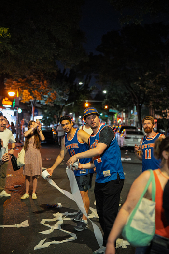 Williamsburg USA 14 June 2026 View of fans celebrating the New York Knicks NBA championship victory with toilet paper streamers on a city street at night. Williamsburg USA 14 June 2026 View of fans celebrating the New York Knicks NBA championship victory with toilet paper streamers on a city street at night.