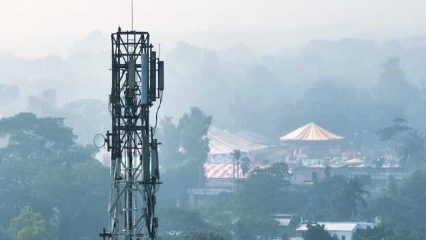 Aerial view of a technician working on a cell tower Bangladesh.