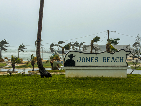 San Jose Tinian Northern Mariana Islands 06 July 2026 View of the Jones Beach sign during a super typhoon with palm trees bending in high winds and rough seas. San Jose Tinian Northern Mariana Islands 06 July 2026 View of the Jones Beach sign during a super typhoon with palm trees bending in high winds and rough seas.