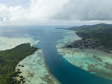 Aerial view of the vibrant turquoise waters meet lush green landscapes revealing the coastal charm of Karimunjawa Central Java Indonesia. Aerial view of the vibrant turquoise waters meet lush green landscapes revealing the coastal charm of Karimunjawa Central Java Indonesia.