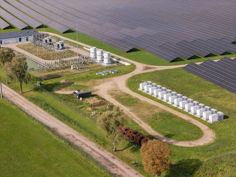 Aerial view of a Battery Energy Storage System at a solar farm with rows of photovoltaic panels electrical infrastructure and green fields in Poland. Aerial view of a Battery Energy Storage System at a solar farm with rows of photovoltaic panels electrical infrastructure and green fields in Poland.