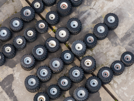 Aerial view of large tractor tires arranged in rows at a harvesting machinery producer facility in Plock Masovian Voivodeship Poland. Aerial view of large tractor tires arranged in rows at a harvesting machinery producer facility in Plock Masovian Voivodeship Poland.