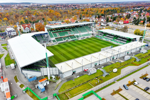 Furth Germany 02 May 2026 Aerial view of Sportpark Ronhof Thomas Sommer featuring the green football pitch modern grandstands and surrounding autumn trees in the background.