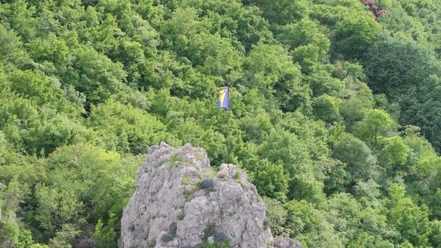 Aerial view of flag on rocky cliff in Mostar Bosnia and Herzegovina. Aerial view of flag on rocky cliff in Mostar Bosnia and Herzegovina.