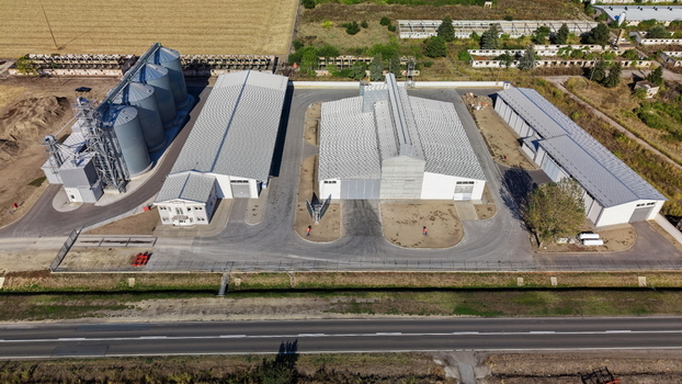 Aerial view of storage silo Bavaniste with large warehouse buildings and paved yard in the rural landscape of Bavaniste Vojvodina Serbia.