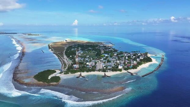 Aerial view of Thulusdhoo island and turquoise lagoons Maldives.