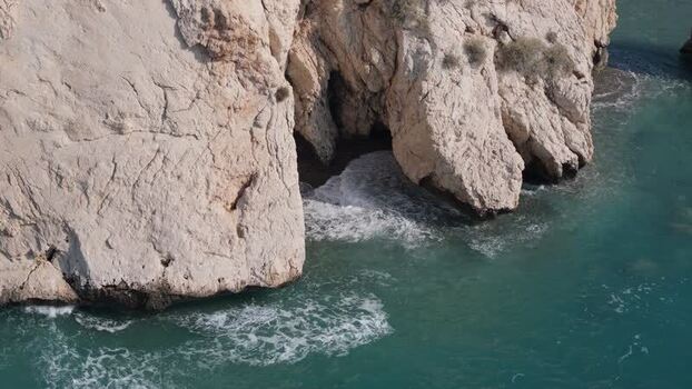 Aerial view of rocky coastline and sea cave in Nicosia Cyprus.