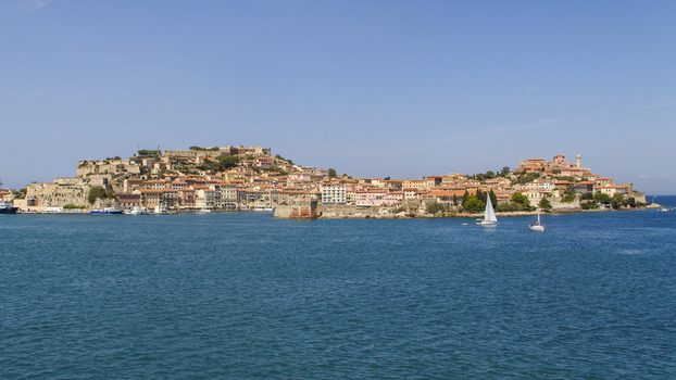 View of the historic city nestled along the coast with terracotta rooftops and ancient walls contrasting with the shimmering turquoise sea Portoferraio Elba Tuscany Italy. View of the historic city nestled along the coast with terracotta rooftops and ancient walls contrasting with the shimmering turquoise sea Portoferraio Elba Tuscany Italy.