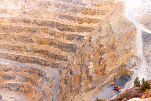 Geamana Romania 21 September 2026 Aerial view of the Geamana open pit mine with deep terraced excavations winding access roads and heavy mining machinery in the industrial landscape. Geamana Romania 21 September 2026 Aerial view of the Geamana open pit mine with deep terraced excavations winding access roads and heavy mining machinery in the industrial landscape.