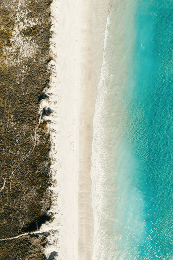 Aerial view of Puwheke Beach with white sand turquoise water and coastal vegetation Karikari Peninsula Northland Region New Zealand.