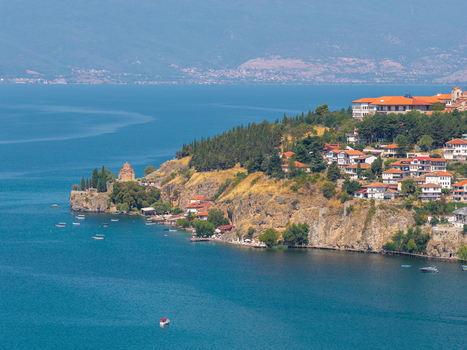 Aerial view of the Church of St. John at Kaneo on a cliff overlooking Lake Ohrid with traditional houses and trees in Ohrid Municipality of Ohrid North Macedonia.