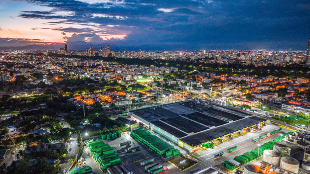 Aerial view of Cerveceria Nacional Dominicana Puerta 5 industrial facility with green crates and trucks at dusk in Santo Domingo Distrito Nacional Dominican Republic.