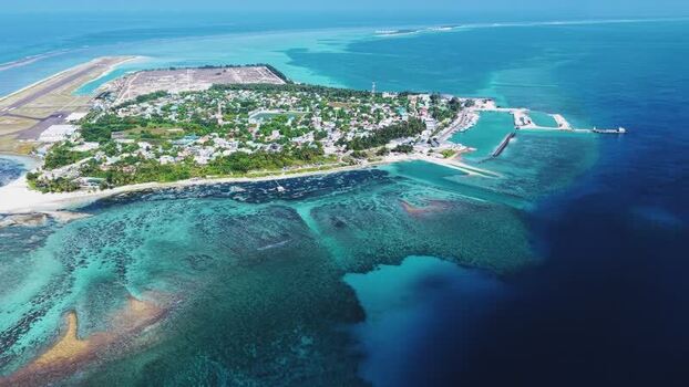Aerial view of Kudahuvadhoo island and coral reefs Maldives. Aerial view of Kudahuvadhoo island and coral reefs Maldives.