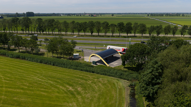 Middenbeemster Noord Holland Netherlands 20 June 2026 Aerial view of Fastned Charging Station with solar panels located along a highway in a rural landscape.