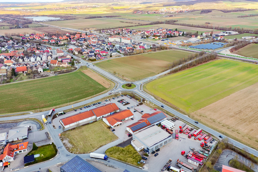 Aerial view of the town of Forchheim showing a roundabout commercial warehouses and surrounding agricultural fields Forchheim Bavaria Germany. Aerial view of the town of Forchheim showing a roundabout commercial warehouses and surrounding agricultural fields Forchheim Bavaria Germany.