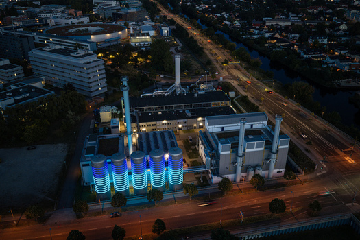 Aerial view of BTB Heat and Power Plant Adlershof with glowing blue tanks visualizing heat energy storage at night in Berlin Berlin Germany. Aerial view of BTB Heat and Power Plant Adlershof with glowing blue tanks visualizing heat energy storage at night in Berlin Berlin Germany.