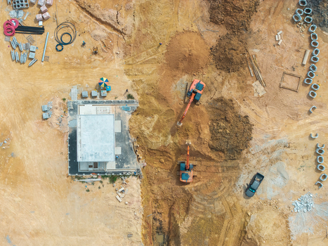 Aerial view of a construction site with heavy excavators working on earthworks and building foundations in Bukit Tambun Penang Malaysia. Aerial view of a construction site with heavy excavators working on earthworks and building foundations in Bukit Tambun Penang Malaysia.