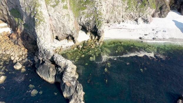 Aerial view of Glenlough Bay with rugged cliffs Ireland.