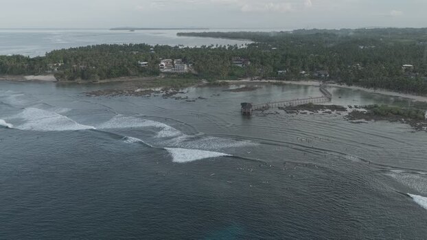 Aerial view of surfers and boardwalk on Siargao Island Philippines.