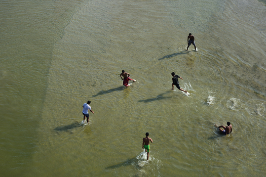 Kushtia District Khulna Division Bangladesh 10 March 2020 View of young men playing and wading in the shallow clear water of a river. Kushtia District Khulna Division Bangladesh 10 March 2020 View of young men playing and wading in the shallow clear water of a river.