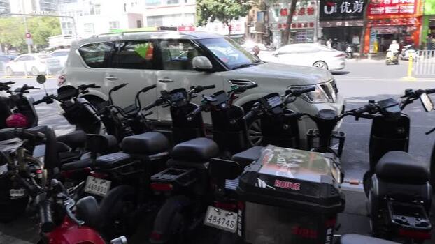 View of parked electric scooters on a city street China. View of parked electric scooters on a city street China.