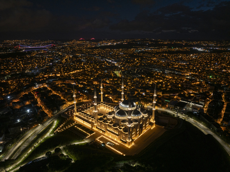 Aerial view of the illuminated Grand Camlica Mosque at night surrounded by the sprawling urban landscape and city lights of Uskudar Istanbul Turkey. Aerial view of the illuminated Grand Camlica Mosque at night surrounded by the sprawling urban landscape and city lights of Uskudar Istanbul Turkey.