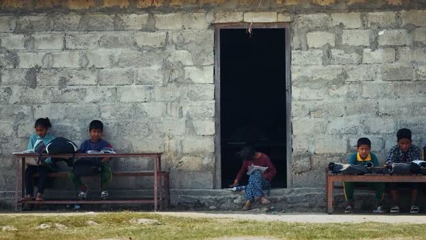 View of children studying outside a school building Nepal.