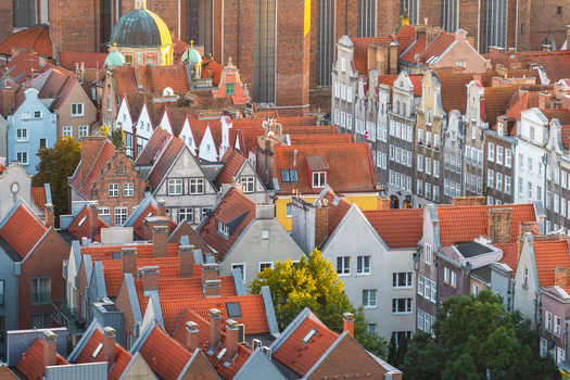 Aerial view of historic townhouses with red tiled roofs and the prominent St. Marys Church in the city center Gdansk Pomeranian Voivodeship Poland. Aerial view of historic townhouses with red tiled roofs and the prominent St. Marys Church in the city center Gdansk Pomeranian Voivodeship Poland.