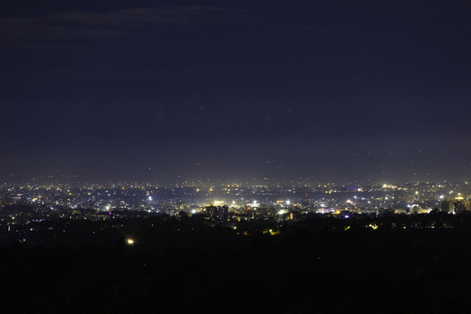 View of the Nairobi city skyline illuminated at night with glowing street lights and buildings against a dark horizon in Nairobi Nairobi County Kenya.