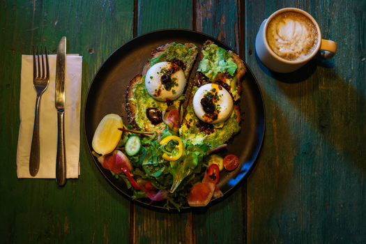 View of avocado toast topped with poached eggs and a side salad served at Ruba s Bakery Bistro in San Jose del Cabo Baja California Sur Mexico.