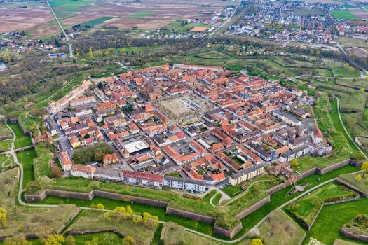 Aerial view of the star shaped fortress with orange rooftops and green moats a testament to military architecture Neuf Brisach Grand Est France.