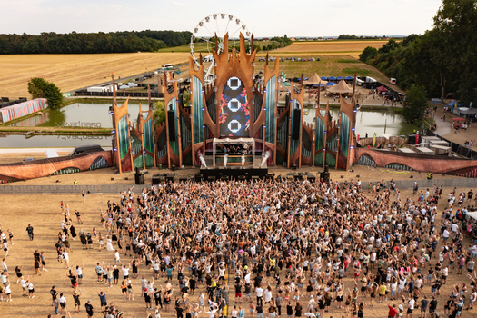 Herzogenaurach Germany 22 July 2022 Aerial view of the Open Beatz Festival main stage with a large crowd of people dancing and a Ferris wheel in the background. Herzogenaurach Germany 22 July 2022 Aerial view of the Open Beatz Festival main stage with a large crowd of people dancing and a Ferris wheel in the background.