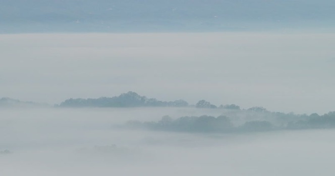 Aerial view of Balze del Valdarno rock formations in the fog Italy.