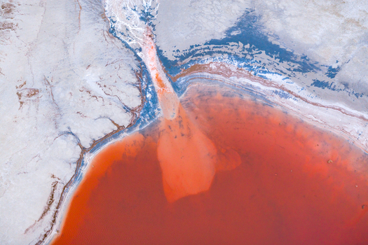 Aerial view of striking red waters contrast sharply with the pale cracked earth a stark reminder of nature s power and fragility Salt Lake City Utah United States. Aerial view of striking red waters contrast sharply with the pale cracked earth a stark reminder of nature s power and fragility Salt Lake City Utah United States.