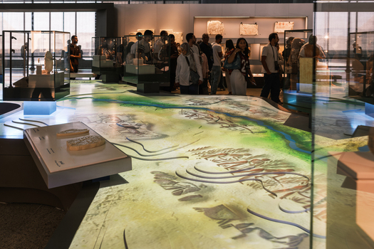 Giza Egypt 16 May 2026 View of the Grand Egyptian Museum interior featuring visitors exploring ancient artifacts and a large illuminated floor map display.