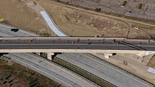 Aerial view of a bridge with people walking across the road surface in Boulder Colorado United States. Aerial view of a bridge with people walking across the road surface in Boulder Colorado United States.