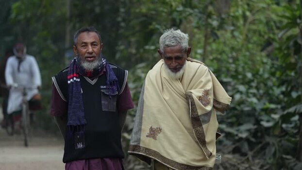 View of two elderly men walking along a rural path Bangladesh. View of two elderly men walking along a rural path Bangladesh.