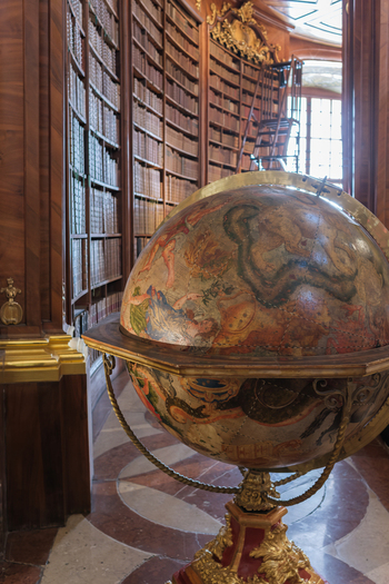 Vienna Austria 26 April 2026 View of the ornate antique globe in the State Hall of the Austrian National Library with historic wooden bookshelves in the background. Vienna Austria 26 April 2026 View of the ornate antique globe in the State Hall of the Austrian National Library with historic wooden bookshelves in the background.
