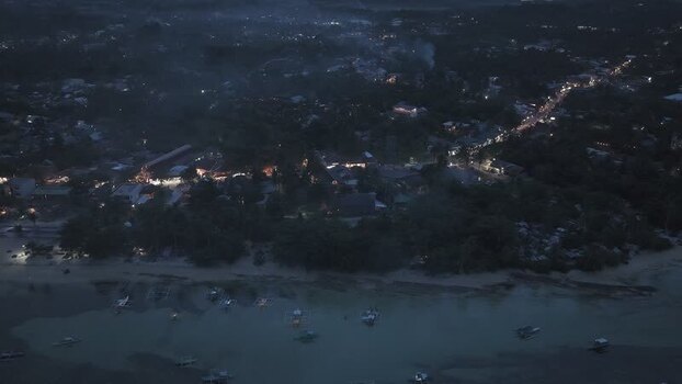 Aerial view of Siargao Island at night with city lights Philippines.