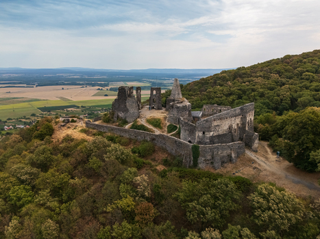 Aerial view of Somlo Castle ruins above forests and fields in Veszprem County Hungary Aerial view of Somlo Castle ruins above forests and fields in Veszprem County Hungary