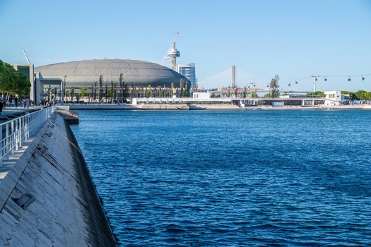 View of the modern architecture of Parque das Nacoes including the Altice Arena and Vasco da Gama Tower along the Tagus River in Lisbon Lisbon Portugal. View of the modern architecture of Parque das Nacoes including the Altice Arena and Vasco da Gama Tower along the Tagus River in Lisbon Lisbon Portugal.
