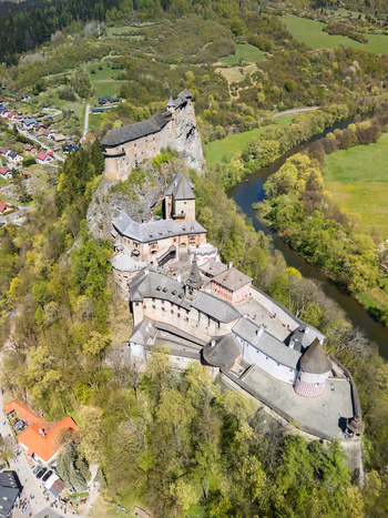 Aerial view of Orava Castle perched on a high rock above the Orava river surrounded by lush green forests in Dolny Kubin Zilinsky kraj Slovakia. Aerial view of Orava Castle perched on a high rock above the Orava river surrounded by lush green forests in Dolny Kubin Zilinsky kraj Slovakia.