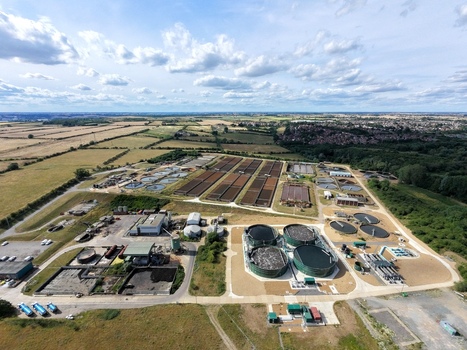 Aerial view of Broadholme water recycling centre with circular tanks and treatment basins surrounded by fields and green landscape in Rushden England United Kingdom. Aerial view of Broadholme water recycling centre with circular tanks and treatment basins surrounded by fields and green landscape in Rushden England United Kingdom.