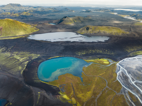 Aerial view of the Landmannalaugar s vibrant turquoise lake nestled within a stark volcanic landscape Highlands Iceland.