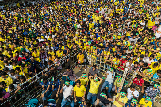 Dhaka Bangladesh 20 June 2026 Aerial view of Dhaka University Campus filled with a massive crowd of football fans wearing yellow jerseys and holding Brazil flags. Dhaka Bangladesh 20 June 2026 Aerial view of Dhaka University Campus filled with a massive crowd of football fans wearing yellow jerseys and holding Brazil flags.