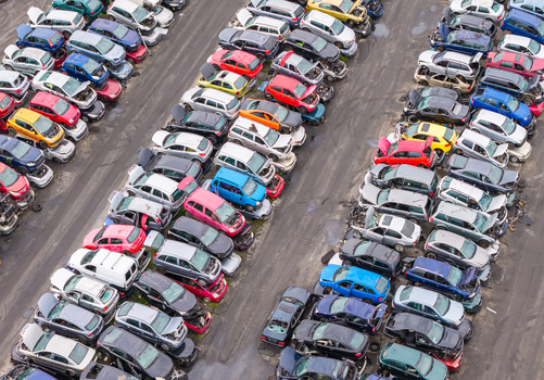 Aerial view of end of life vehicle recycling facility with rows of salvaged cars parked in an organized lot in Gdansk Pomeranian Voivodeshi Poland.